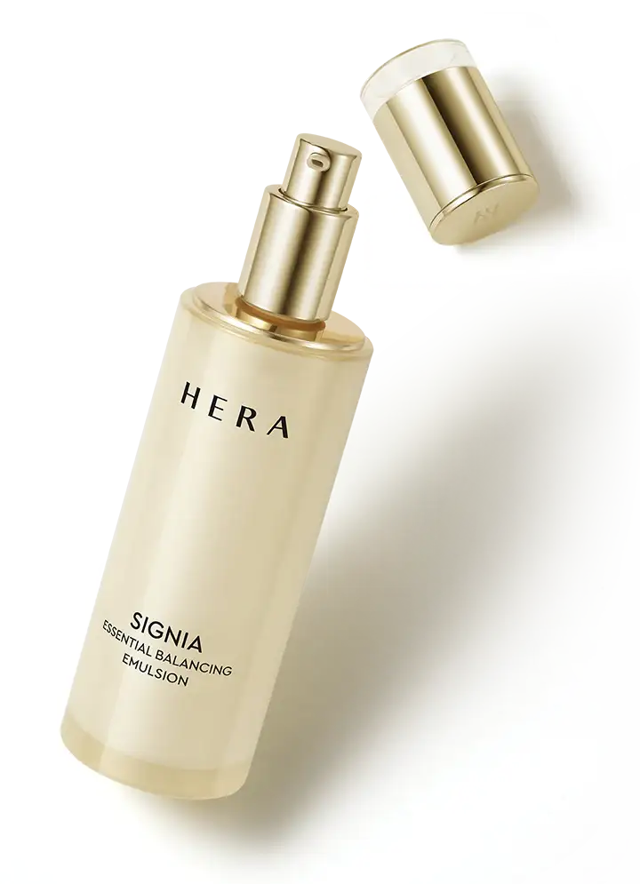 Hera Signia Essential Balancing Emulsion skincare bottle with gold pump and cap on white background