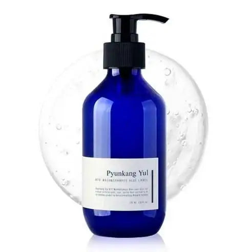 Blue glass bottle with pump dispenser, labeled Pyunkang Yul, set against bubble background for skincare routine