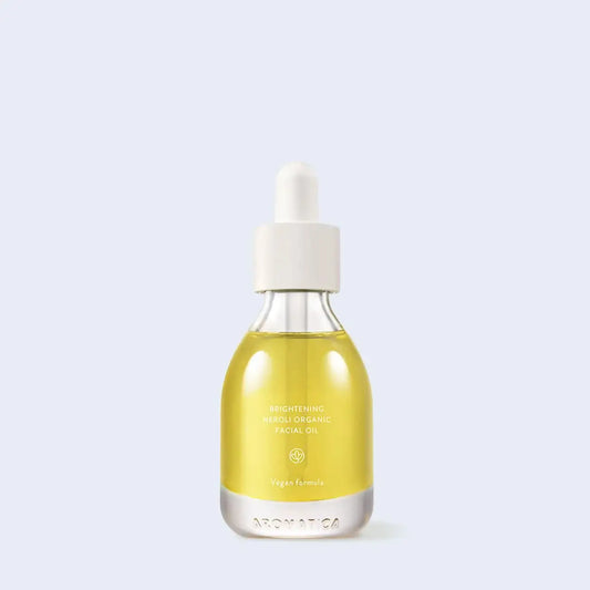Brightening Neroli Organic Facial Oil in clear glass bottle with dropper, vegan formula for radiant skin