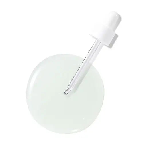 Clear dropper bottle with light green serum, ideal for holistic skincare routines and radiant wellness.