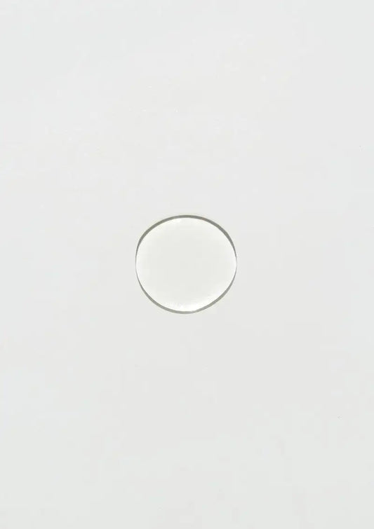 Clear skincare serum drop on white background, showcasing purity and hydration for radiant skin.