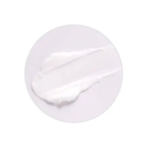 Smooth white skincare cream swatch on clean background, ideal for radiant skin routines