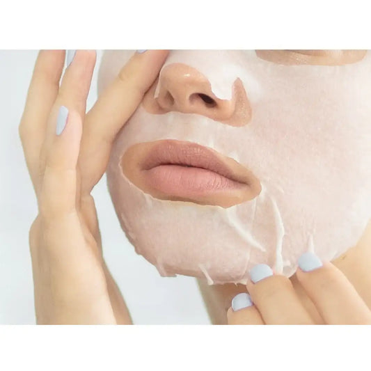 Woman applying hydrating sheet mask for glowing skin wellness routine